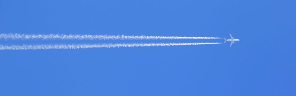 Airplane trail against blue sky
